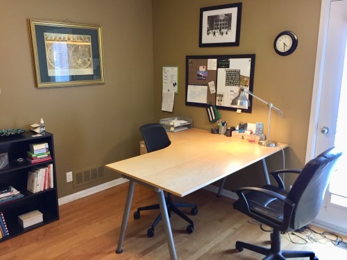 home office with a neat desk and an organized bookshelf