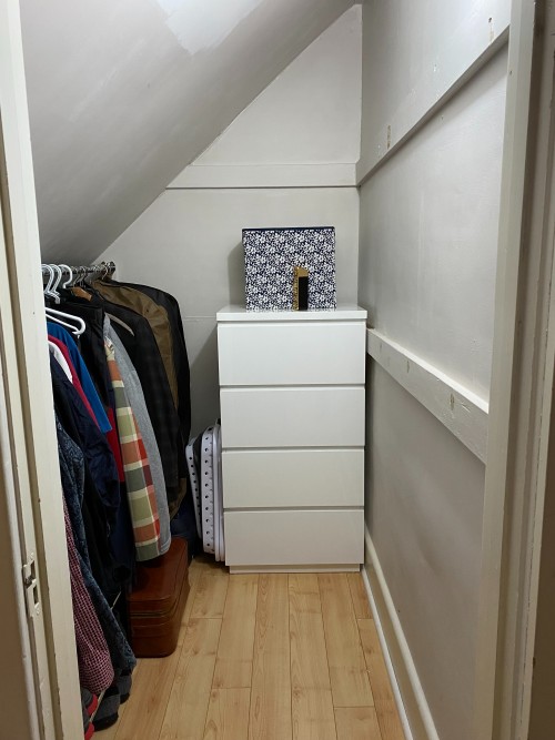 small closet with slanted ceiling plus a 4-drawer dresser