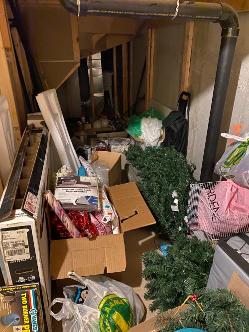 boxes, paint cans, building materials, Christmas trees and other items are scattered