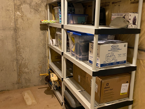 boxes and other items are neatly stored on the shelves