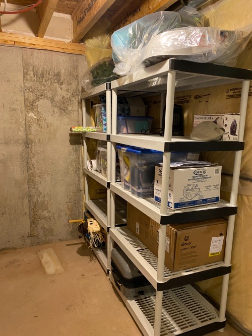 boxes and other items are neatly stored on the shelves