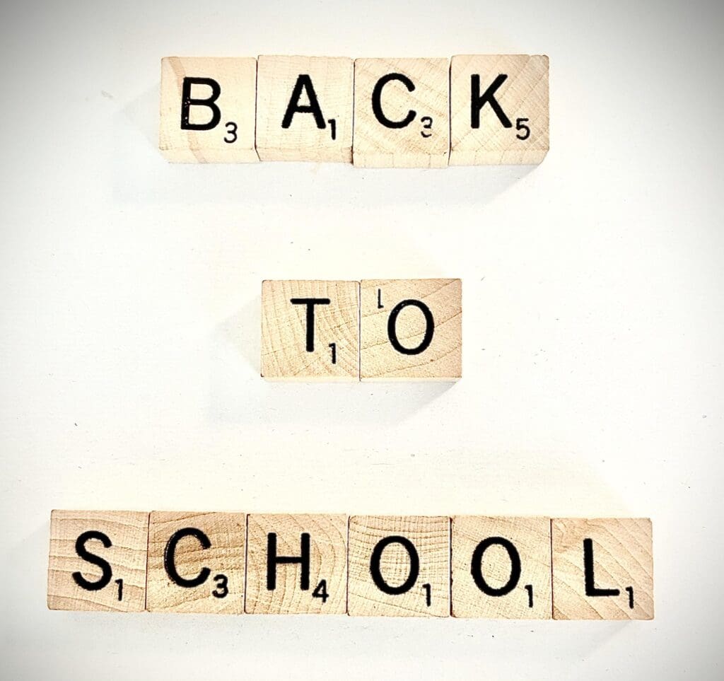 Scrabble tiles spelling Back To School on a white background