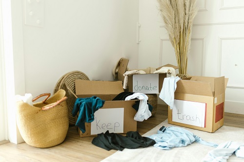 Stacks of boxes and household items sitting in a room of a home.