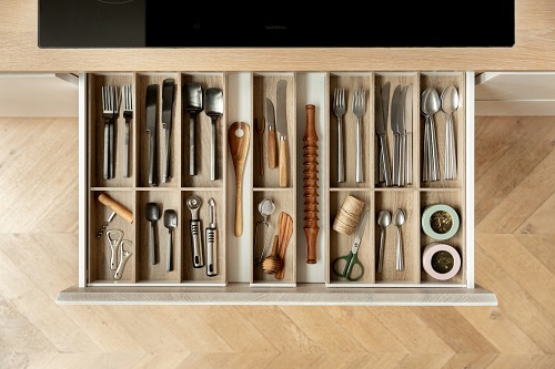 An open drawer divided with various items that are all organized